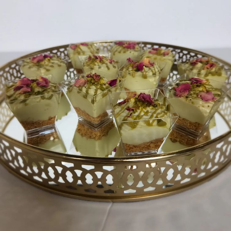 Sweet Natalia layered dessert cups arranged on a gold tray