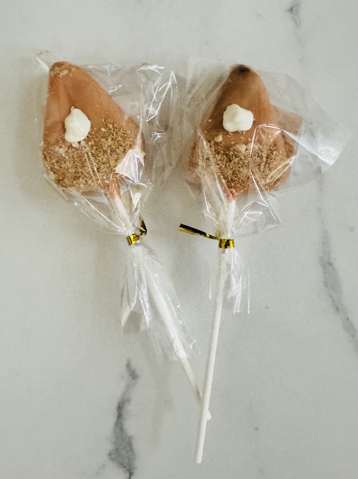 Crumb-coated cake pops with a swirl of cream
